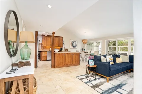 a living room with furniture a flat screen tv and a table