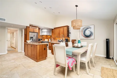 a dining room with granite countertop a table chairs and a kitchen view