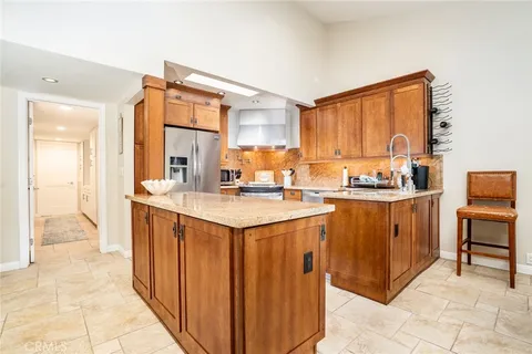 a kitchen with stainless steel appliances granite countertop a stove and a refrigerator