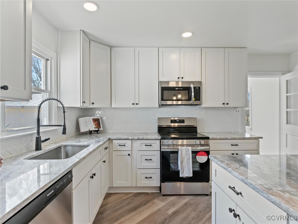 5521 Richmond Road Amelia Court House, VA 23002 - Photo 17 of 49 a kitchen with cabinets stainless steel appliances a sink and a counter space