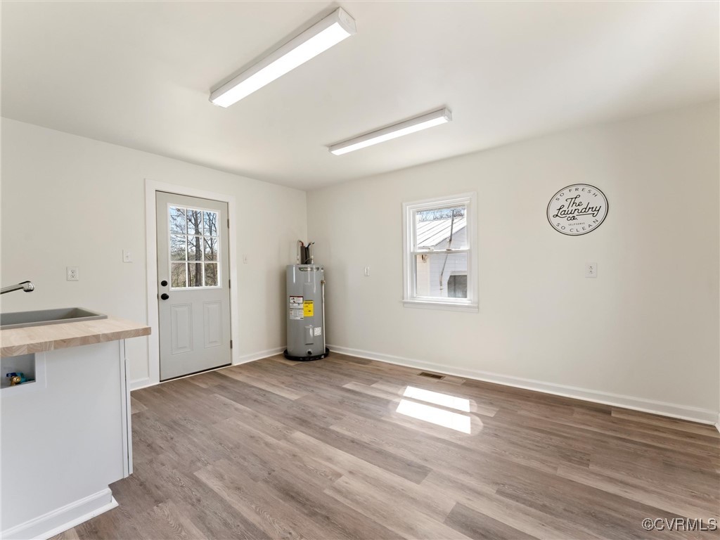 5521 Richmond Road Amelia Court House, VA 23002 - Photo 21 of 49 a view of a big room with wooden floor and windows