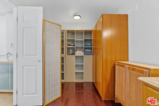 a view of a hallway with wooden floor and closet
