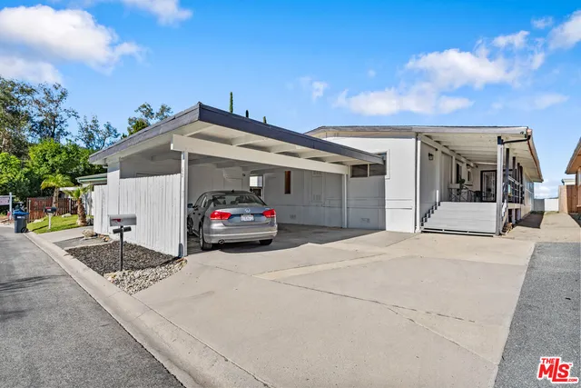 a view of a car park in front of house