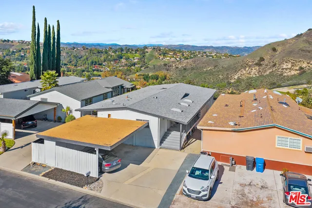 an aerial view of residential houses with outdoor space