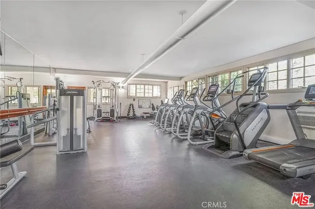 a view of a room with lots of gym equipment