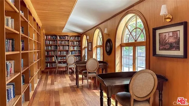 a view of a livingroom with furniture window and wooden floor