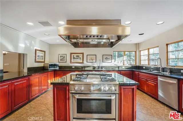 a kitchen with stainless steel appliances granite countertop a stove and a sink