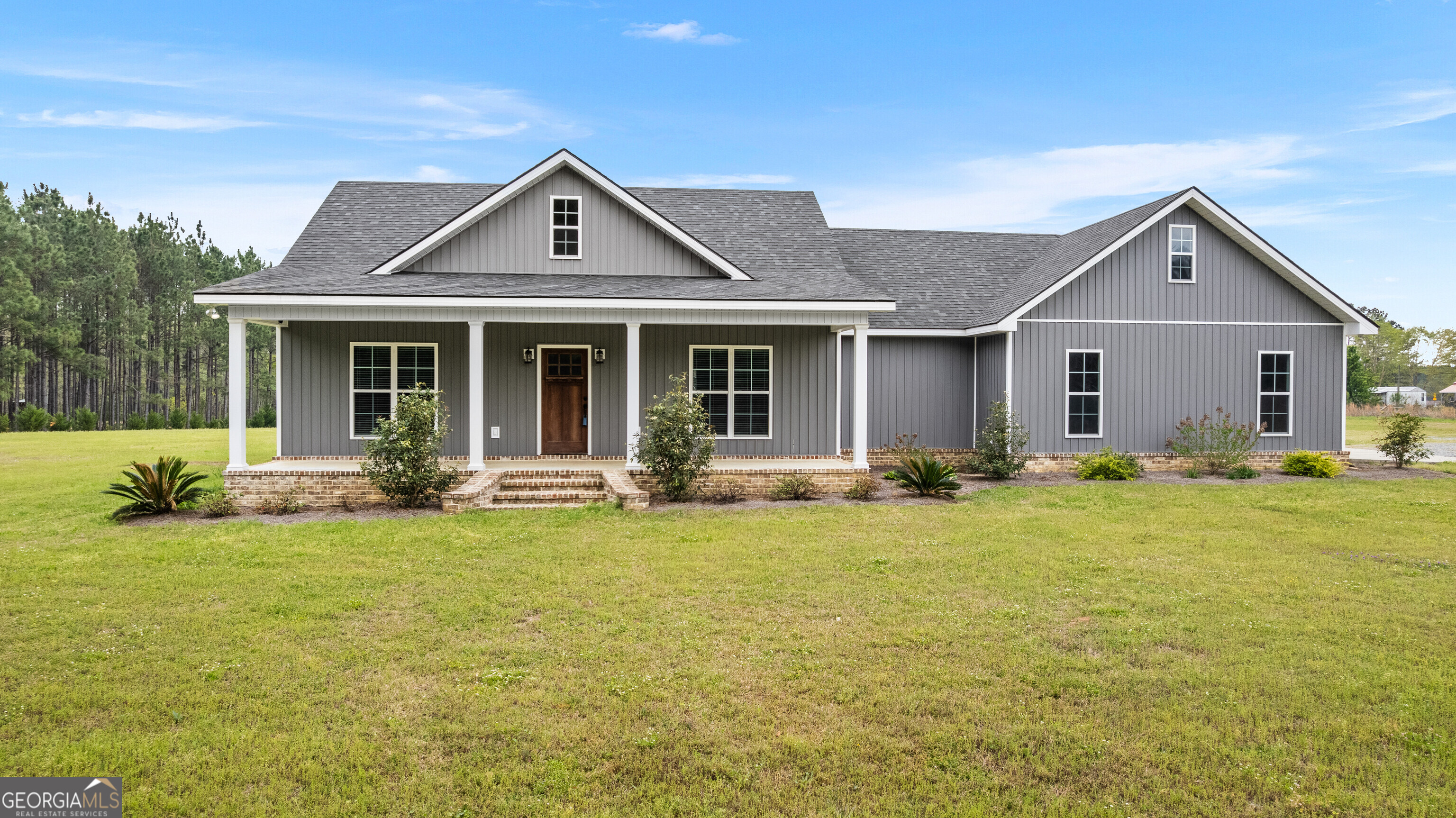 134 Holder-Sanders Road Cochran, GA 31014 - Photo 1 of 1 a front view of a house with swimming pool and porch with furniture