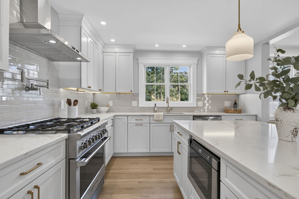 20 Saltonstall Road Medford, MA 02155 - Photo 12 of 41 a kitchen with kitchen island a sink stove and cabinets