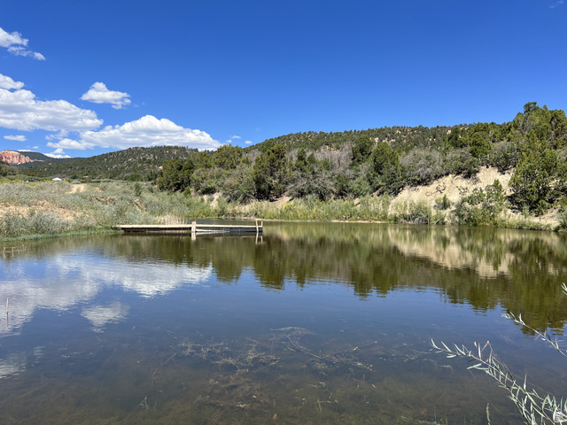 38 Broken Branch Road, Unit 38 Kanab, UT 84741 - Photo 8 of 53 Private HOA pond featuring a wooden dock and surrounding natural landscape