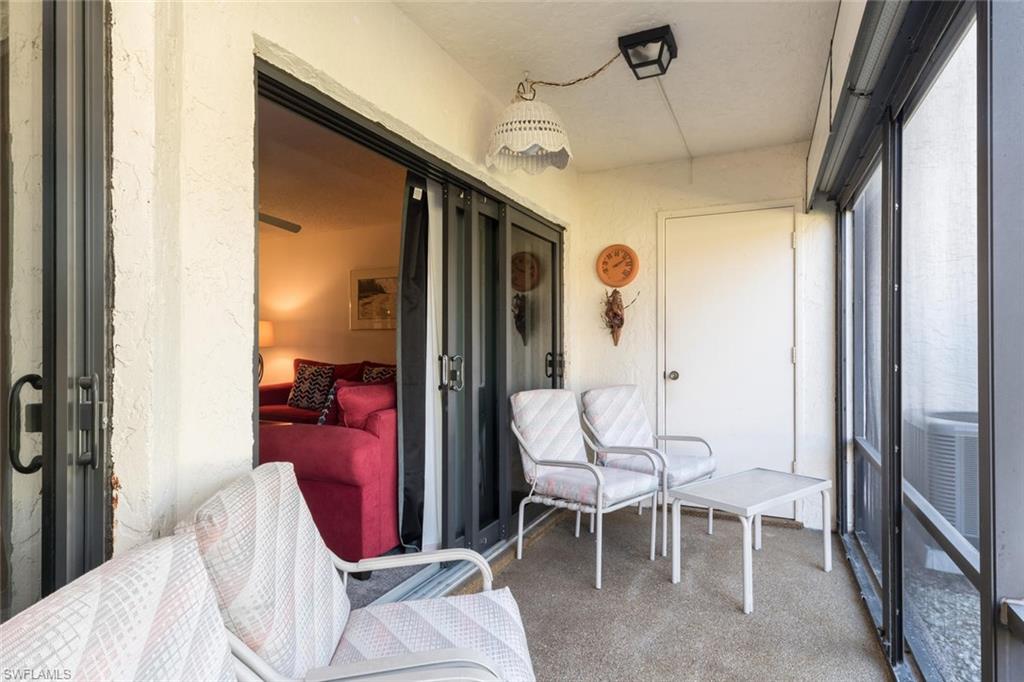 4973 Pepper Circle, Unit F105 Naples, FL 34113 - Photo 18 of 20 a living room with furniture