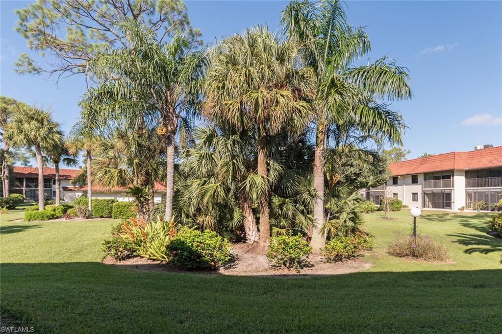4973 Pepper Circle, Unit F105 Naples, FL 34113 - Photo 19 of 20 a view of a house with a garden