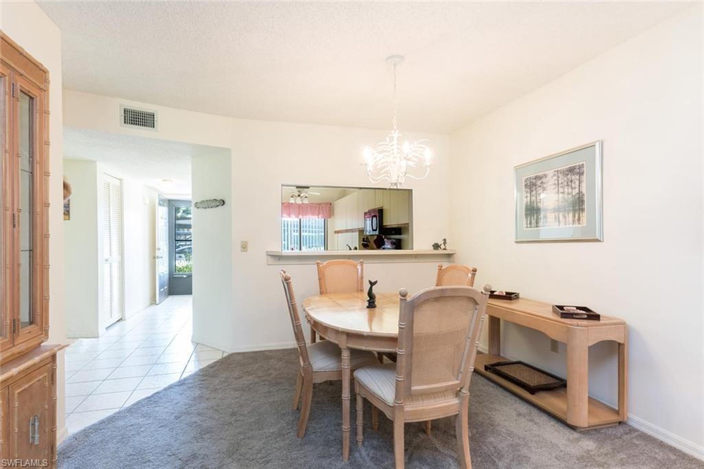 4973 Pepper Circle, Unit F105 Naples, FL 34113 - Photo 8 of 20 a dining room with furniture and window