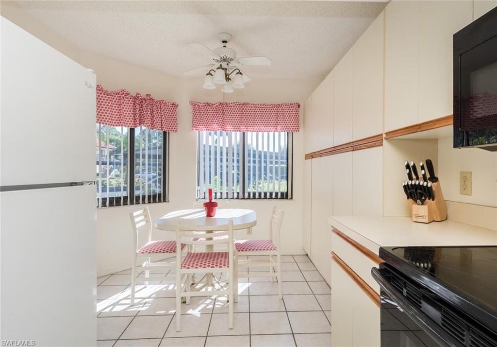 4973 Pepper Circle, Unit F105 Naples, FL 34113 - Photo 9 of 20 a very nice looking room with a large window
