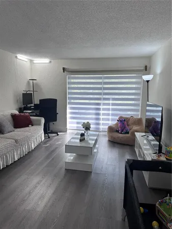 a livingroom with furniture and a window
