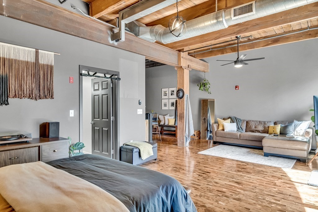 210 Broadway, Unit 103 Everett, MA 02149 - Photo 3 of 16 a bedroom with a large bed and a couch