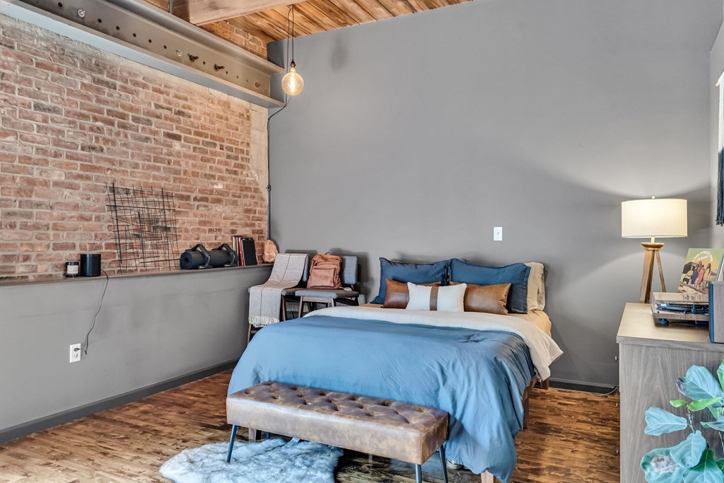 210 Broadway, Unit 103 Everett, MA 02149 - Photo 7 of 16 a bedroom with bed and a night stand