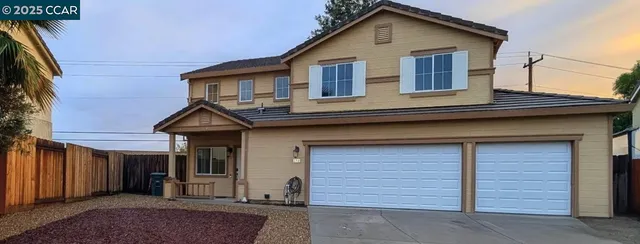 a front view of a house with garage