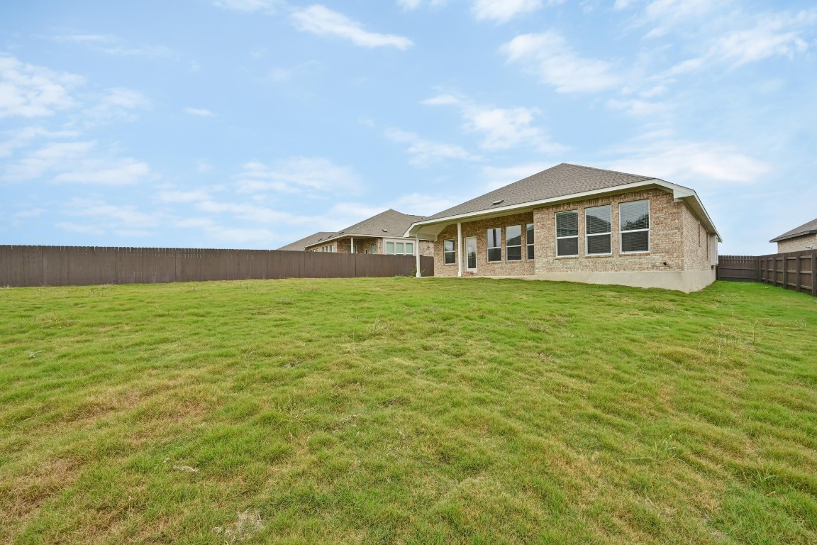 1613 Dove Rnch Road Georgetown, TX 78628 - Photo 21 of 29 a view of a house with a big yard and large trees