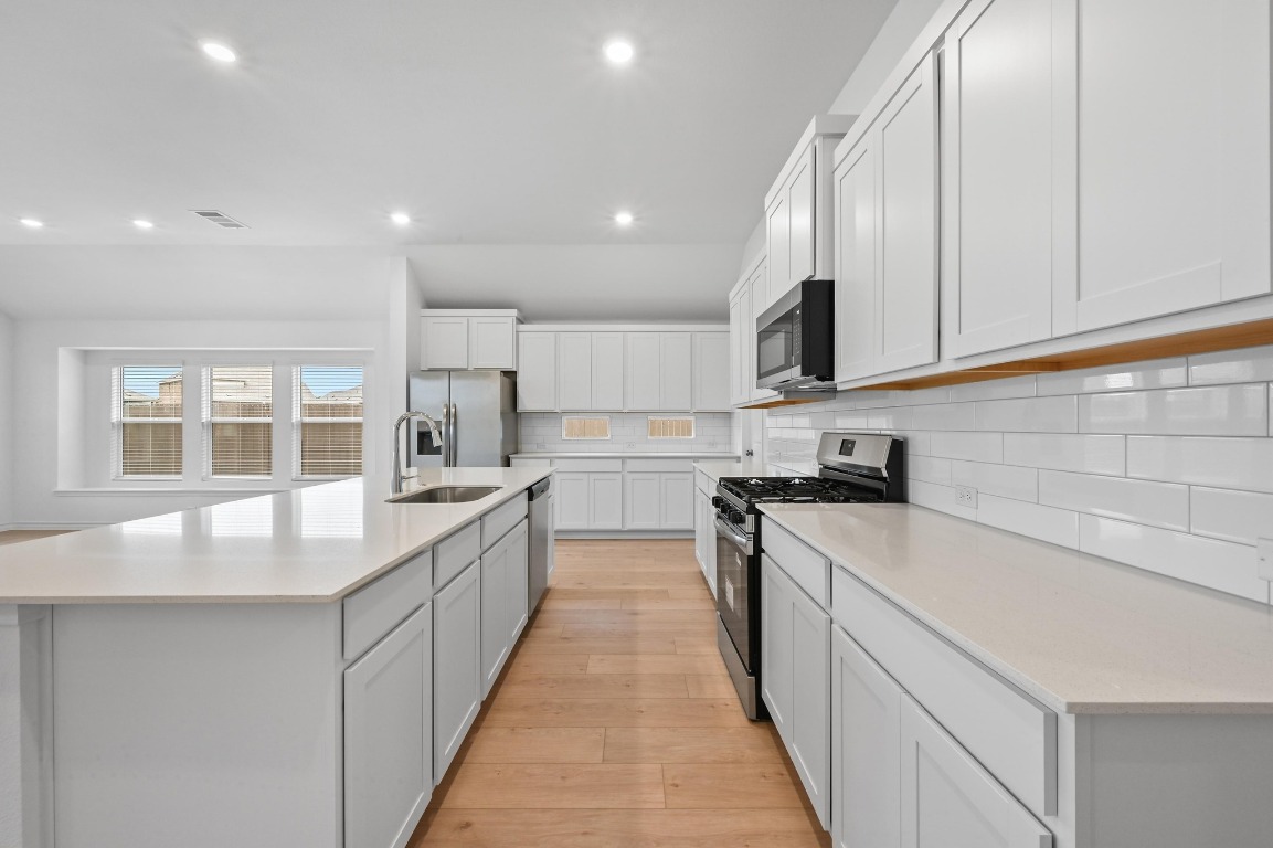 1613 Dove Rnch Road Georgetown, TX 78628 - Photo 5 of 29 a large kitchen with stainless steel appliances granite countertop a sink and cabinets