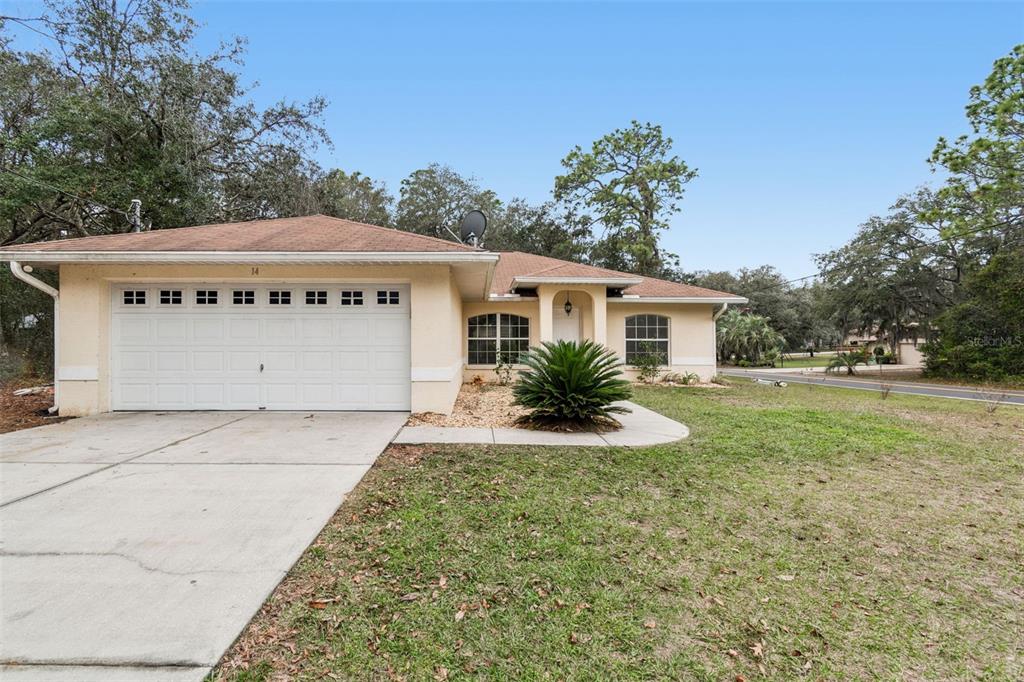 14 South Charles Avenue Inverness, FL 34453 - Photo 2 of 25 a front view of a house with garden
