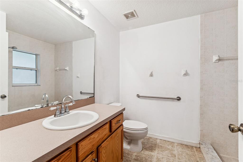 14 South Charles Avenue Inverness, FL 34453 - Photo 22 of 25 a bathroom with a sink toilet and a mirror