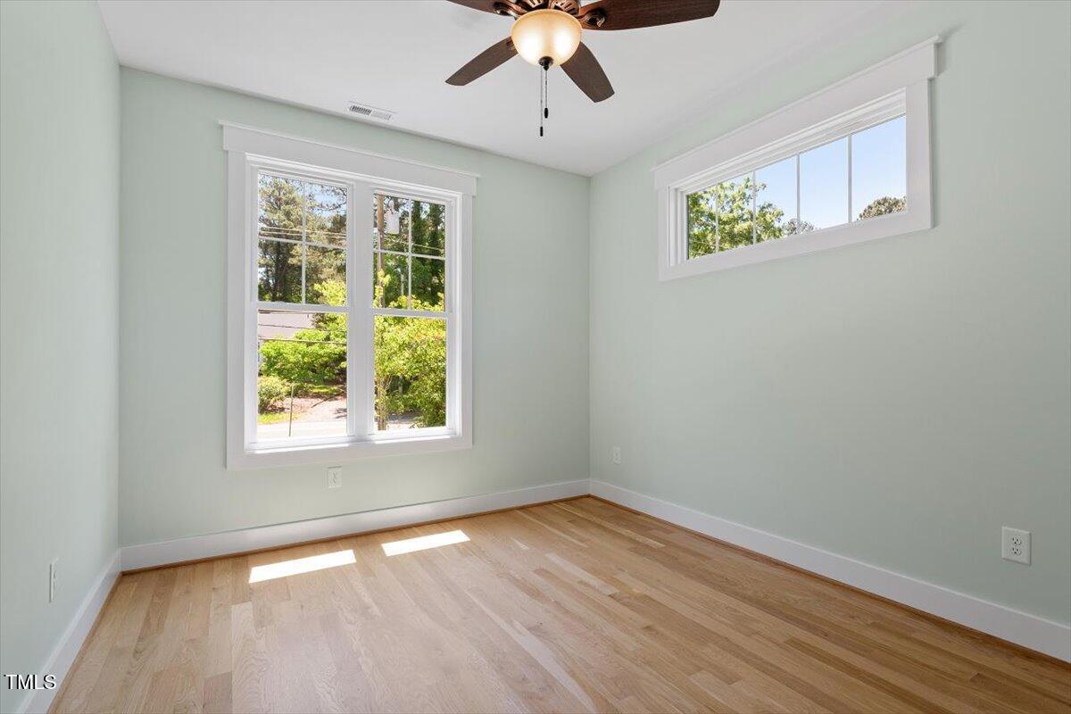 3934 Old Chapel Hill Road Durham, NC 27707 - Photo 35 of 47 a view of an empty room with wooden floor and a window