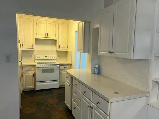 a utility room with cabinets washer and dryer