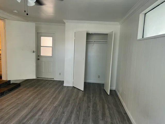 a view of a room with wooden floor and a window