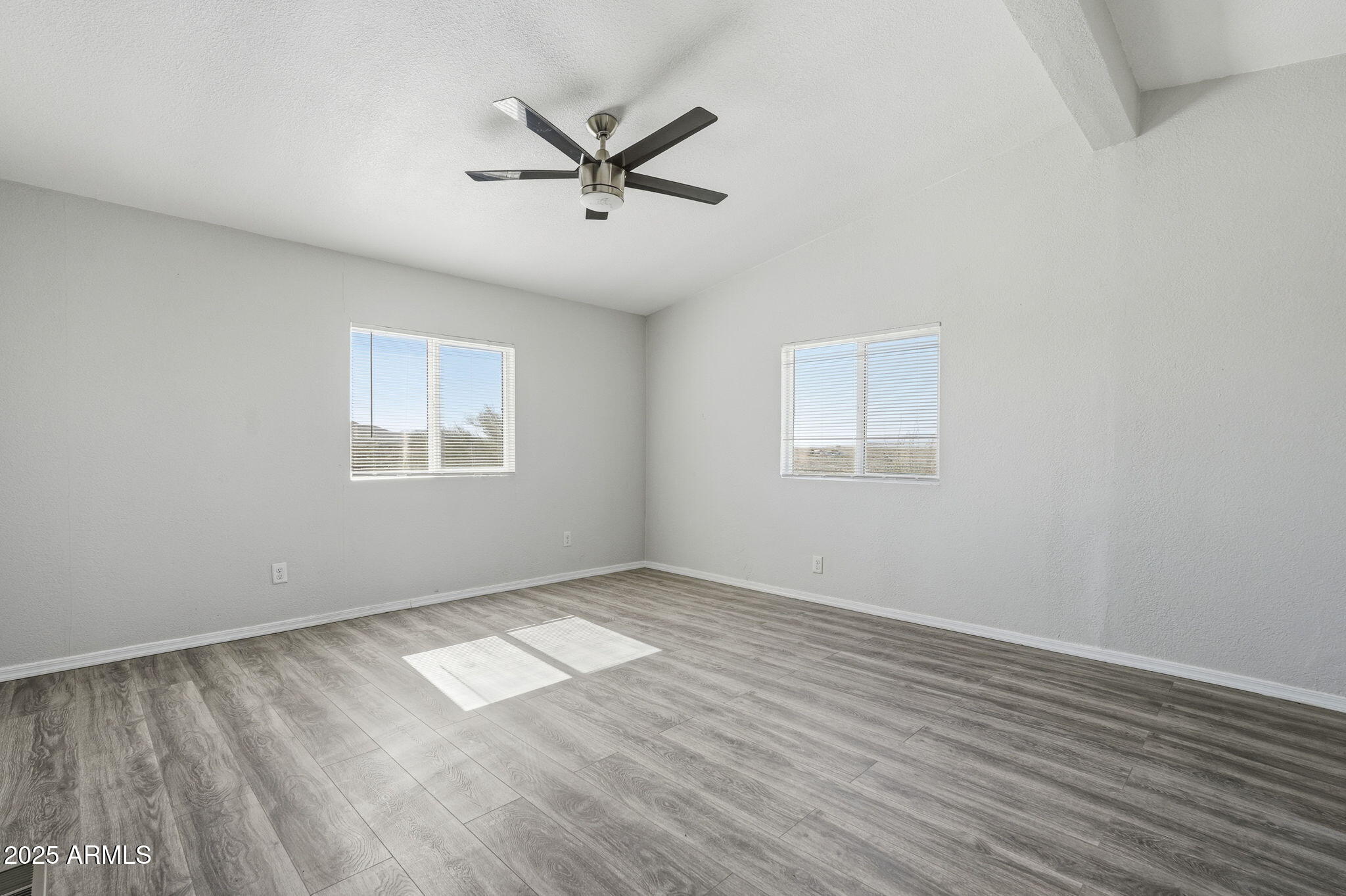 25100 East Lori Road Benson, AZ 85602 - Photo 12 of 30 wooden floor in an empty room with a window