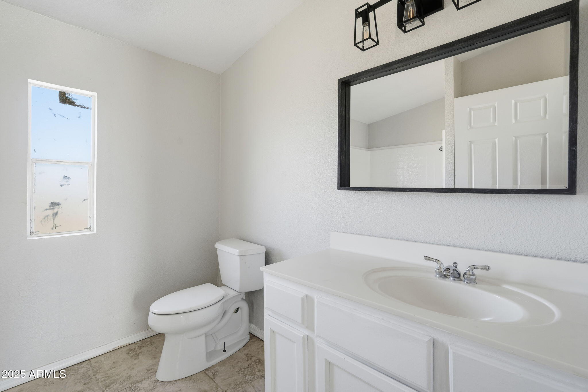 25100 East Lori Road Benson, AZ 85602 - Photo 22 of 30 a bathroom with a toilet sink and mirror