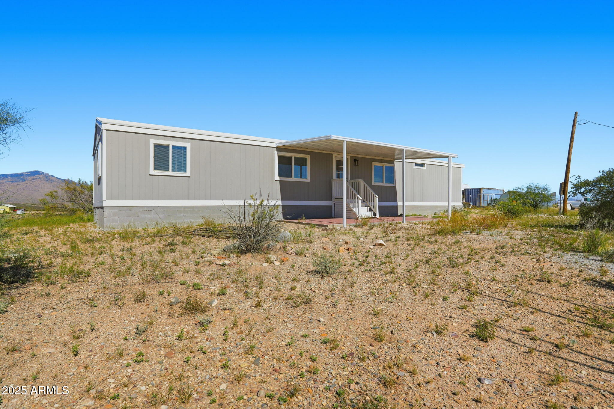 25100 East Lori Road Benson, AZ 85602 - Photo 26 of 30 a house with trees in the background