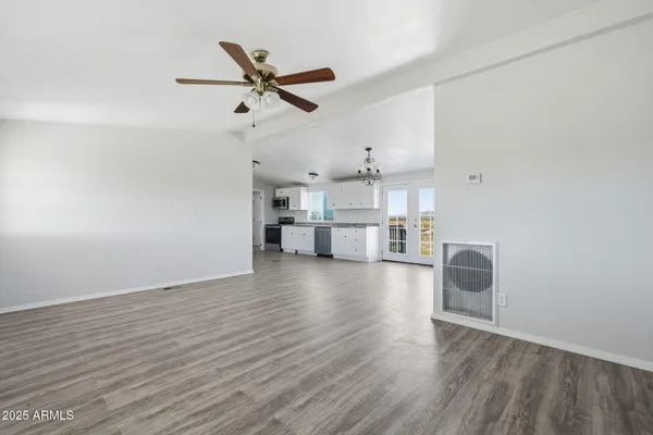 a view of a kitchen with a sink and wooden floor