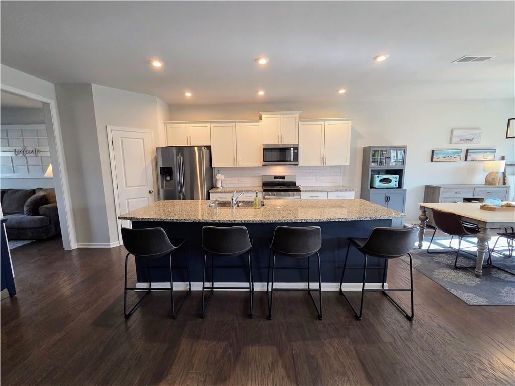 3042 Lowell Road Bethlehem, GA 30620 - Photo 14 of 53 a kitchen with a dining table chairs and wooden floor
