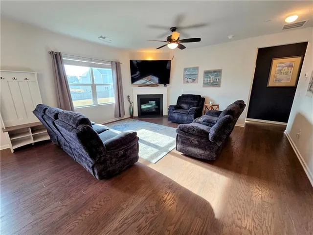 a living room with furniture flat screen tv and a fireplace