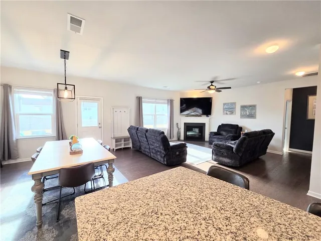 a living room with furniture flat screen tv and a fireplace