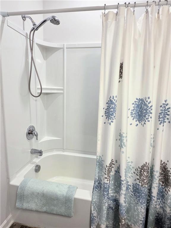 3042 Lowell Road Bethlehem, GA 30620 - Photo 27 of 53 a bathroom with a bathtub and shower