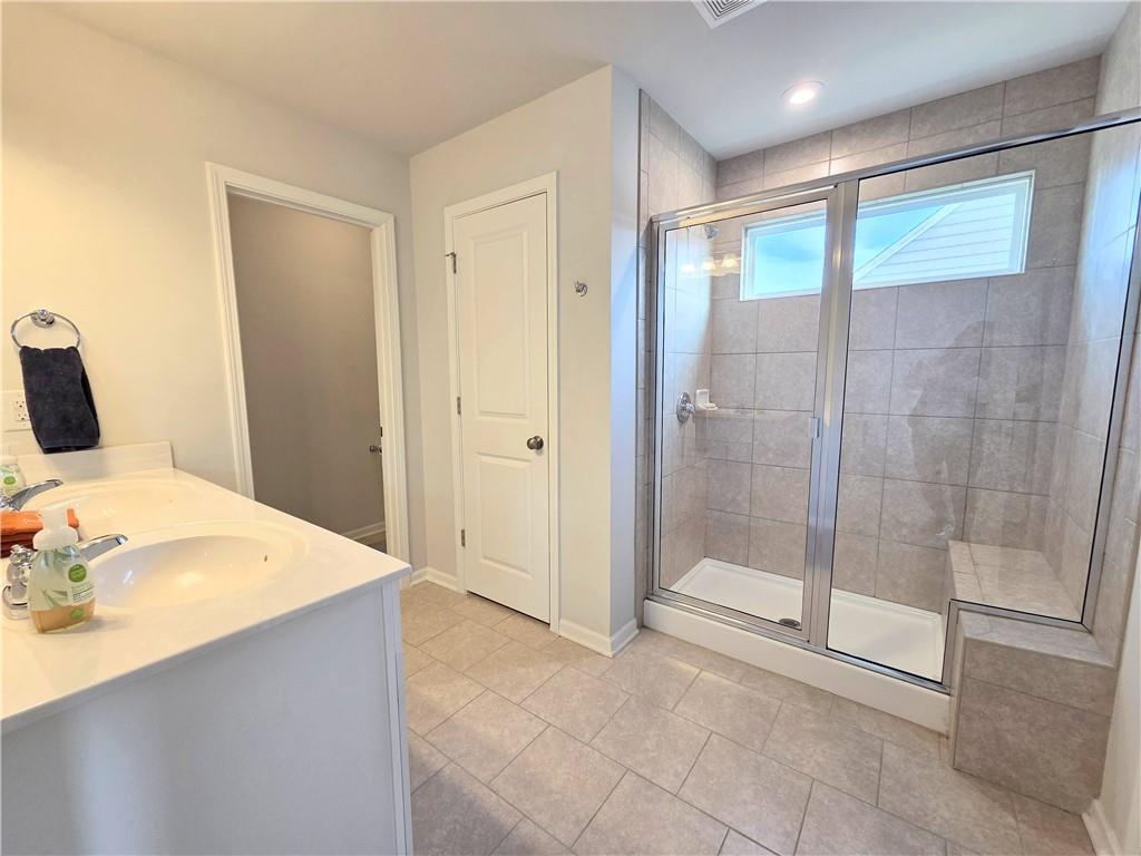 3042 Lowell Road Bethlehem, GA 30620 - Photo 30 of 49 a bathroom with a tub shower and sink