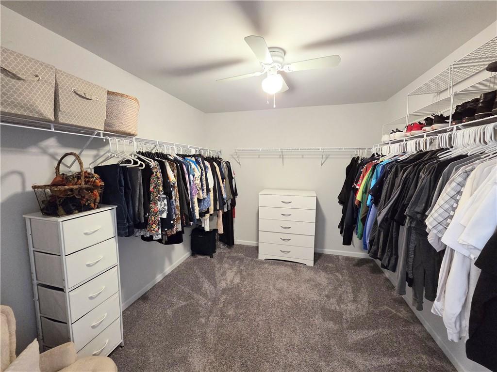 3042 Lowell Road Bethlehem, GA 30620 - Photo 36 of 53 a view of walk in closet with clothes and shoes