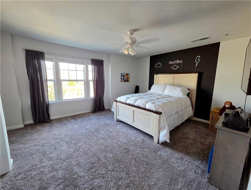 3042 Lowell Road Bethlehem, GA 30620 - Photo 37 of 53 a spacious bedroom with a bed and a dresser
