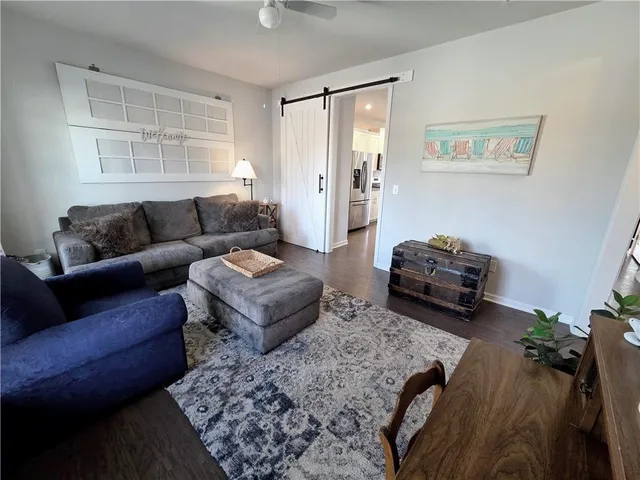 a kitchen with a dining table chairs and wooden floor