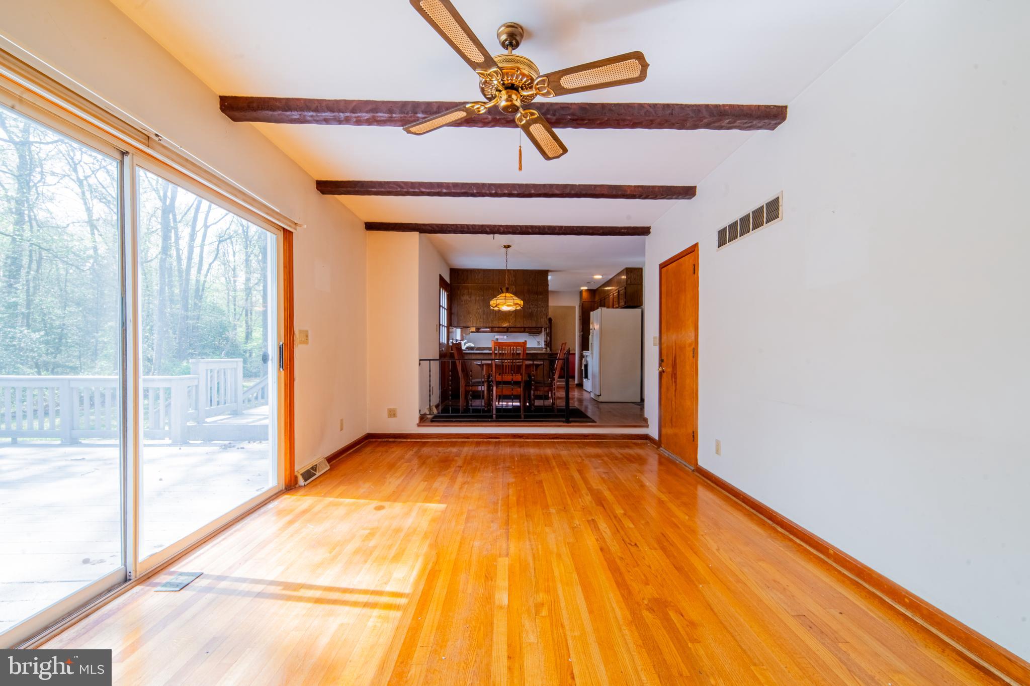 575 Centerton Road Elmer, NJ 08318 - Photo 14 of 28 a view of a room with wooden floor a ceiling fan and windows
