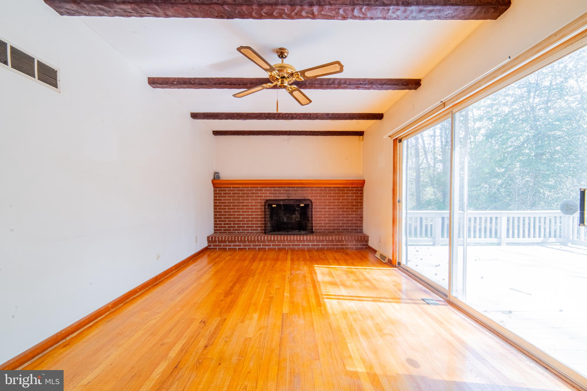 575 Centerton Road Elmer, NJ 08318 - Photo 16 of 28 a view of empty room with a fireplace and wooden floor