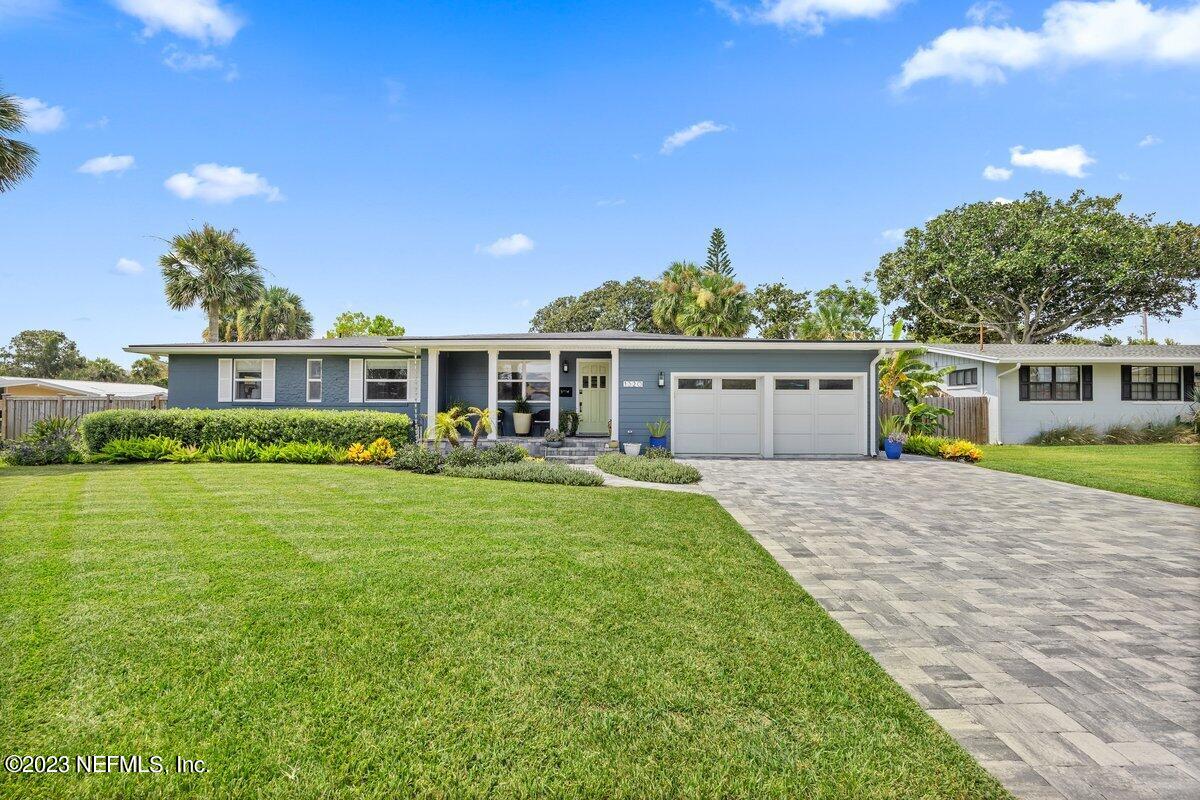 1320 4th Street Neptune Beach, FL 32266 - Photo 2 of 30 a front view of a house with a garden and yard