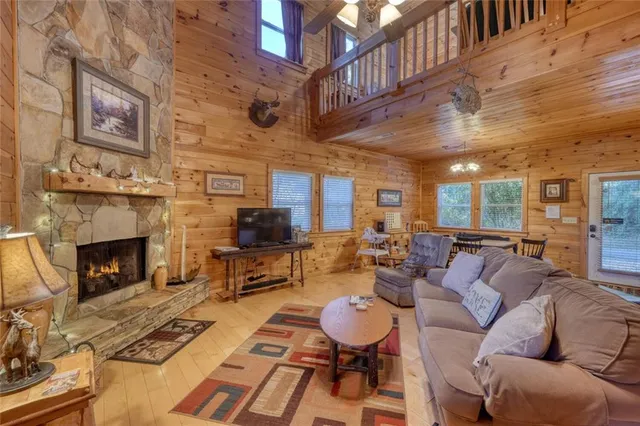 a kitchen with stainless steel appliances granite countertop a refrigerator a stove a sink a dining table and chairs with wooden floor