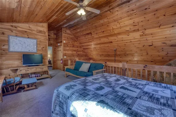 a bed sitting in a spacious bedroom next to a window