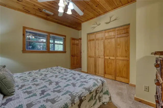 a bathroom with a sink a toilet a mirror and shower