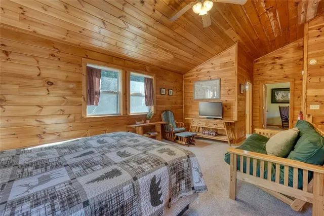 a bed sitting in a spacious bedroom next to a window