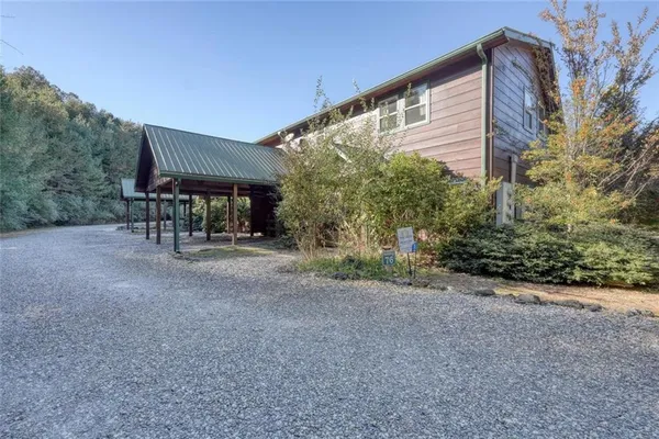 a view of a house with backyard and porch