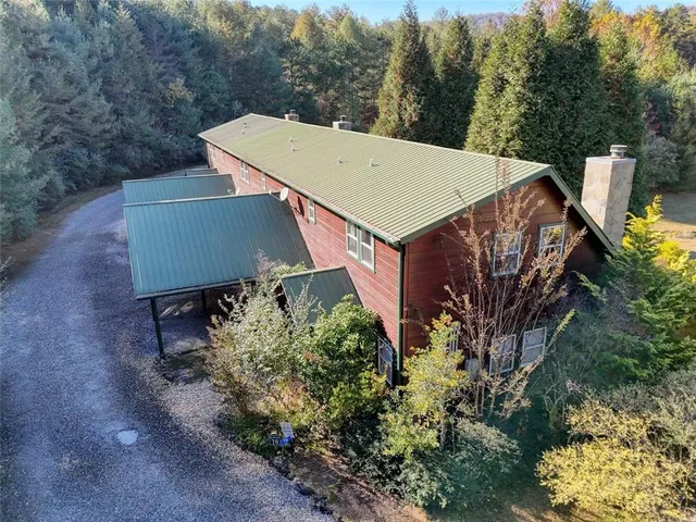 a view of a house with a yard and sitting area